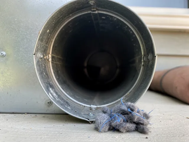 Whitehall Dryer Vent Cleaning technician using specialized equipment to clear severe dryer vent blockage in Whitehall